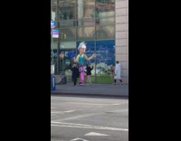 Giant puppet with pink pants and silver hair