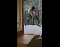 Guy outside of house on balcony dancing on rail