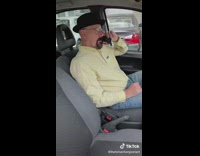 Guy walter white yellow shirt in car on phone chill