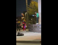 Man green sweater rap music video sidewalk