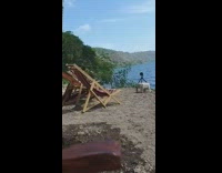 Couple dances on floating raft in lake 