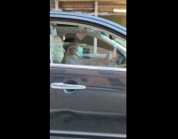 Man has Rick figure on passenger seat of car