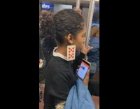 Woman wears number 10 playing card as an earring, red diamonds