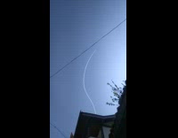 Jet plane make curved contrails on sky