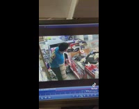 Guy in blue shirt arm stuck in cardboard tube