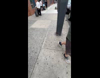 Guys walks with suitcase cursing at street