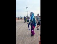 Blue person wearing strange colorful costume