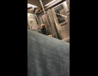 man in blonde wig black hoodie talks to self on subway