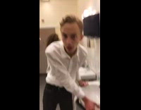 drunk guy white shirt looking around restroom 