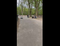 Man wearing dress shirt rides go kart 