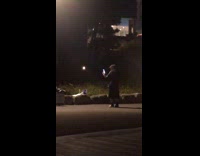 Woman sings loudly in the dark livestream lamppost