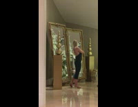 Woman black dress golden balls large mirror