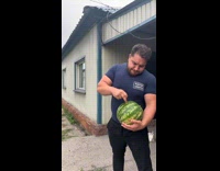 Man pokes holes with finger on watermelon 