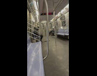 Guy cutting his own hair on subway