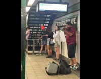 Two guys performing violin and cello in subway station