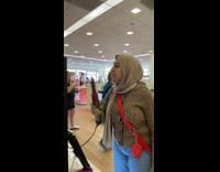 Woman wearing hijab jokingly uses dyson hair dryer 