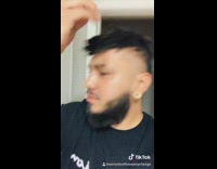 Guy takes hair wig toupee off mirror 