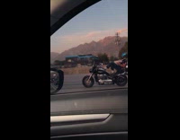 Man lie down on motorcycle at highway