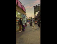 Woman dancing on sidewalk while trying to fight off guy bothering her