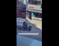 EMT carries treadmill into back of ambulance 