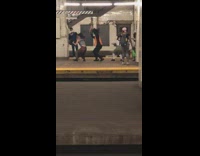 Five people in costumes perform in subway platform