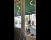 Girl poses at restaurant patio table alone 