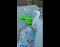 Water bottle with green top squirts water 