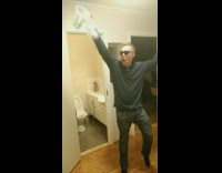 Guy in sunglasses kicks open bathroom door holding a pitcher of soap water and yells Oh Yeah