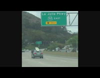 Grey toyota camry car with surfboard on roof
