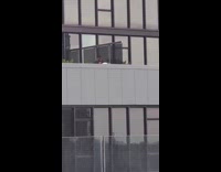 Black shirt guy girl intercourse grey balcony 