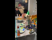 Family singing happy birthday for dog 