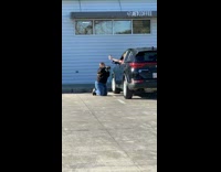 Woman black jacket kneel coffee black car