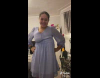 Woman tries on purple dress 