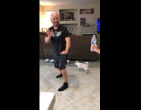 Dad does bottle cap challenge, kicks in the air and falls on his back on tile floor