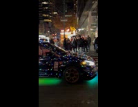 Car covered with Christmas lights night street