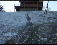 Guy on red sled goes downhill then falls