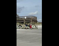 Man shirtless Santa Costume beach bridge pictorial