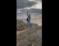 Girl denim jacket hold wine bottle sunset