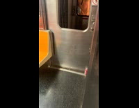 Collab WINY - Filmer shows broken glass window of train door Guy orange shirt on the other car makes a shocked facial expression