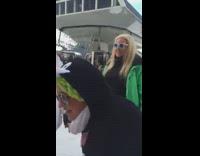 girl in penguin costume tackles girl with white jacket ski lift