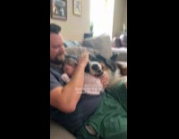 Dog laying with dad and baby