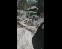 UPS truck spinning down snowy road 