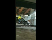 Man rides his bicycle on a highway in New York