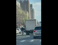 Bicyclist Holds on to White Cargo Truck while Biking 
