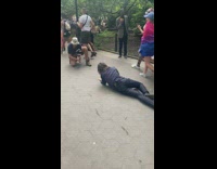 Guy in black crawls on park path 