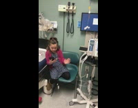 Little girl pink cardigan on phone 