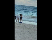 Girl bikini black skirt beach photographer sideways