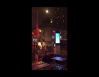 Person in Dinosaur Costume Crosses Street Quickly