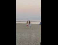 Two girls whip hair crazy dance beach