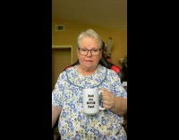 Grandma holding a mug gives some explicit life advice 
